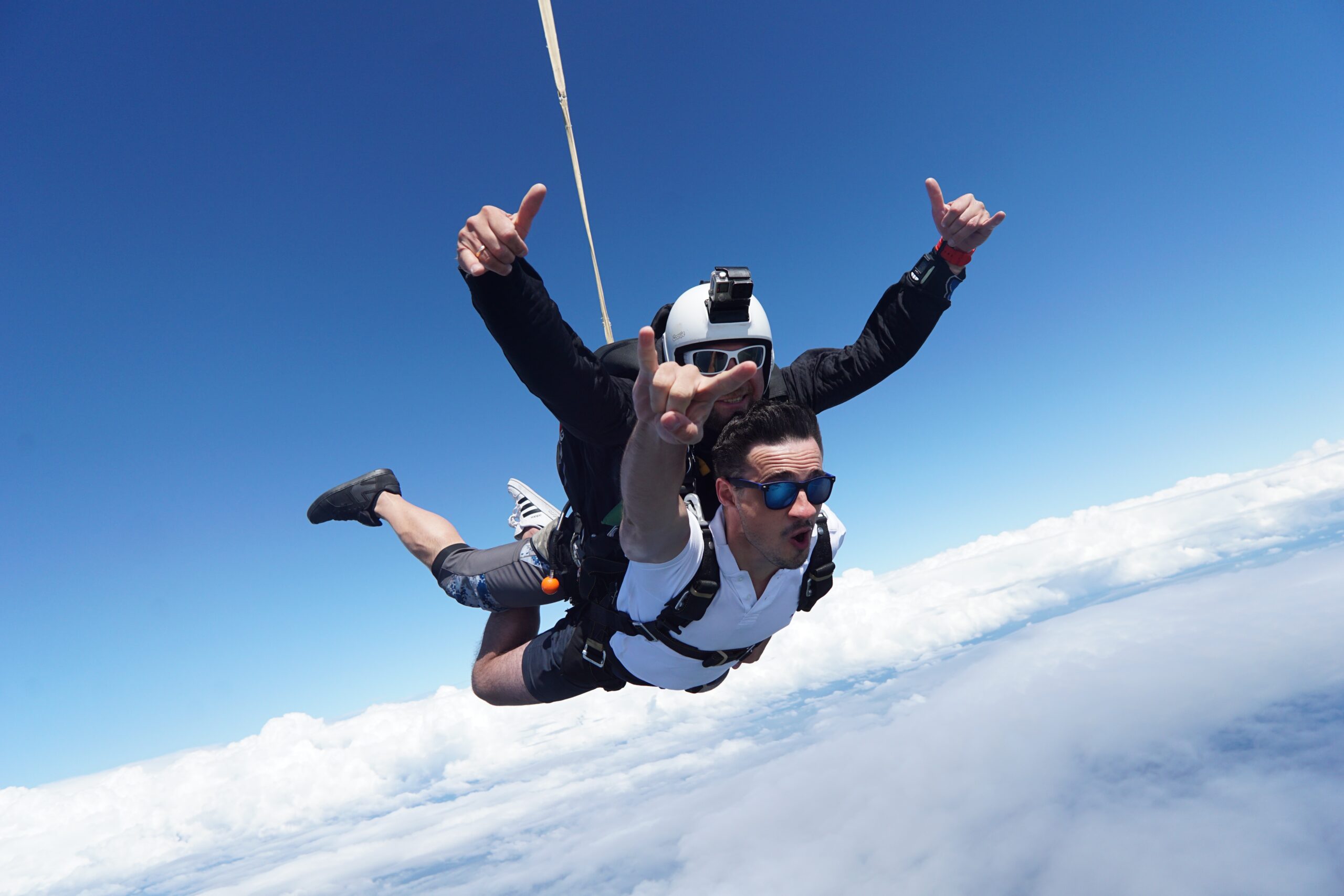 tandem skydivers giving a thumbs up