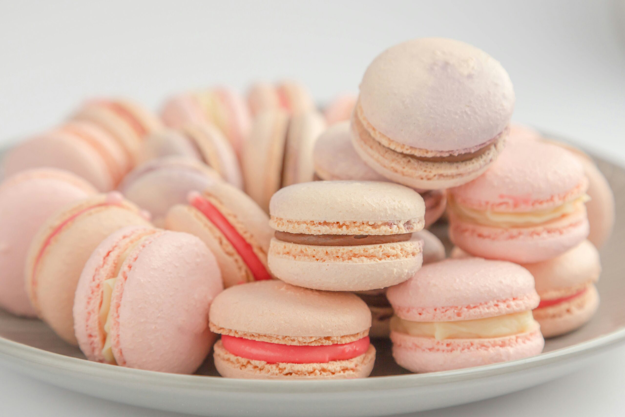 Breast cancer awareness bakesale fundraiser idea a plate of pink macarons