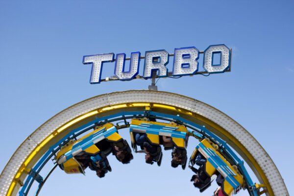 Attendees riding the Turbo roller coaster at a community event, symbolising the energy and excitement of cause-driven experiences