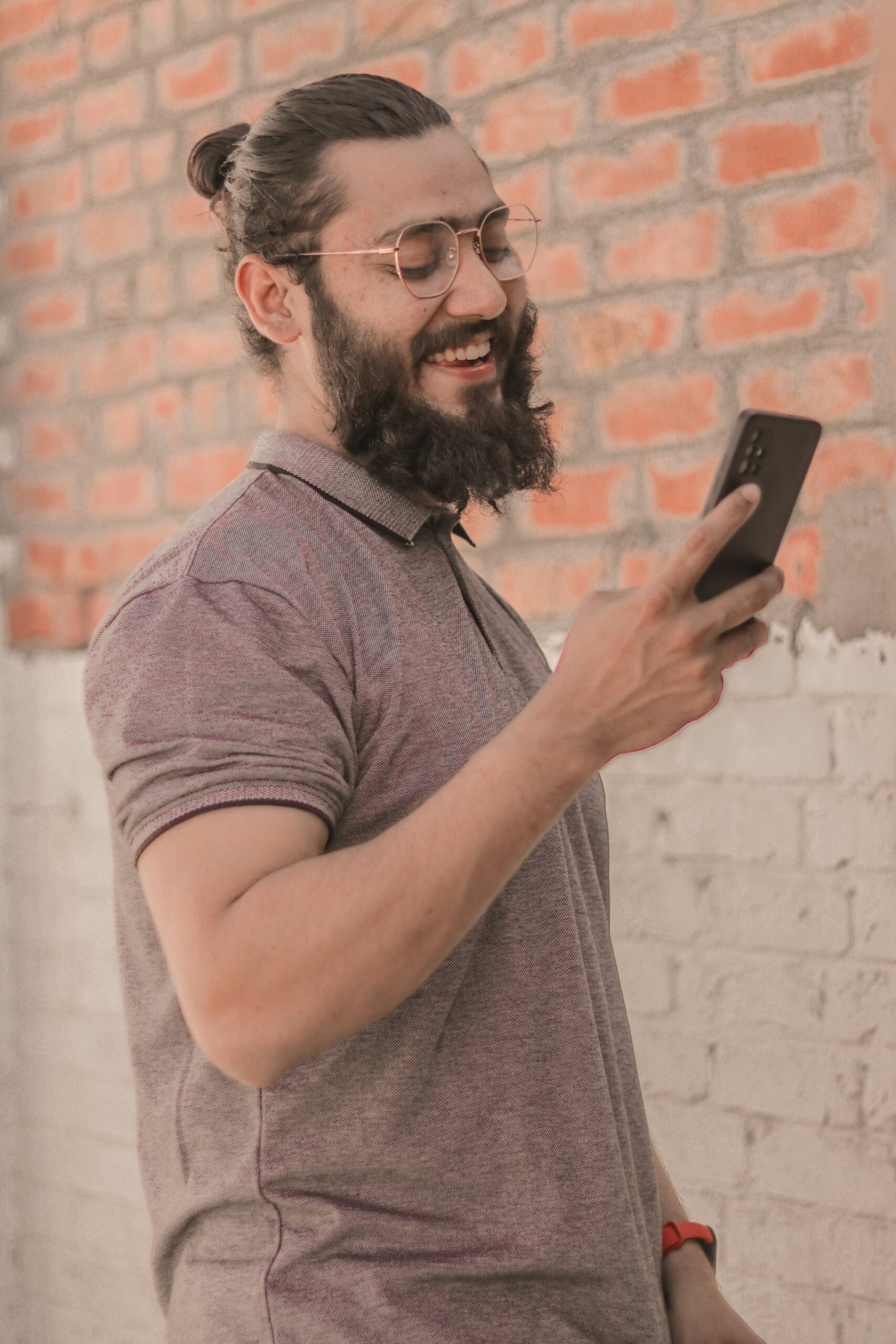 Smiling man using smartphone to purchase raffle tickets online, demonstrating the convenience of mobile fundraising