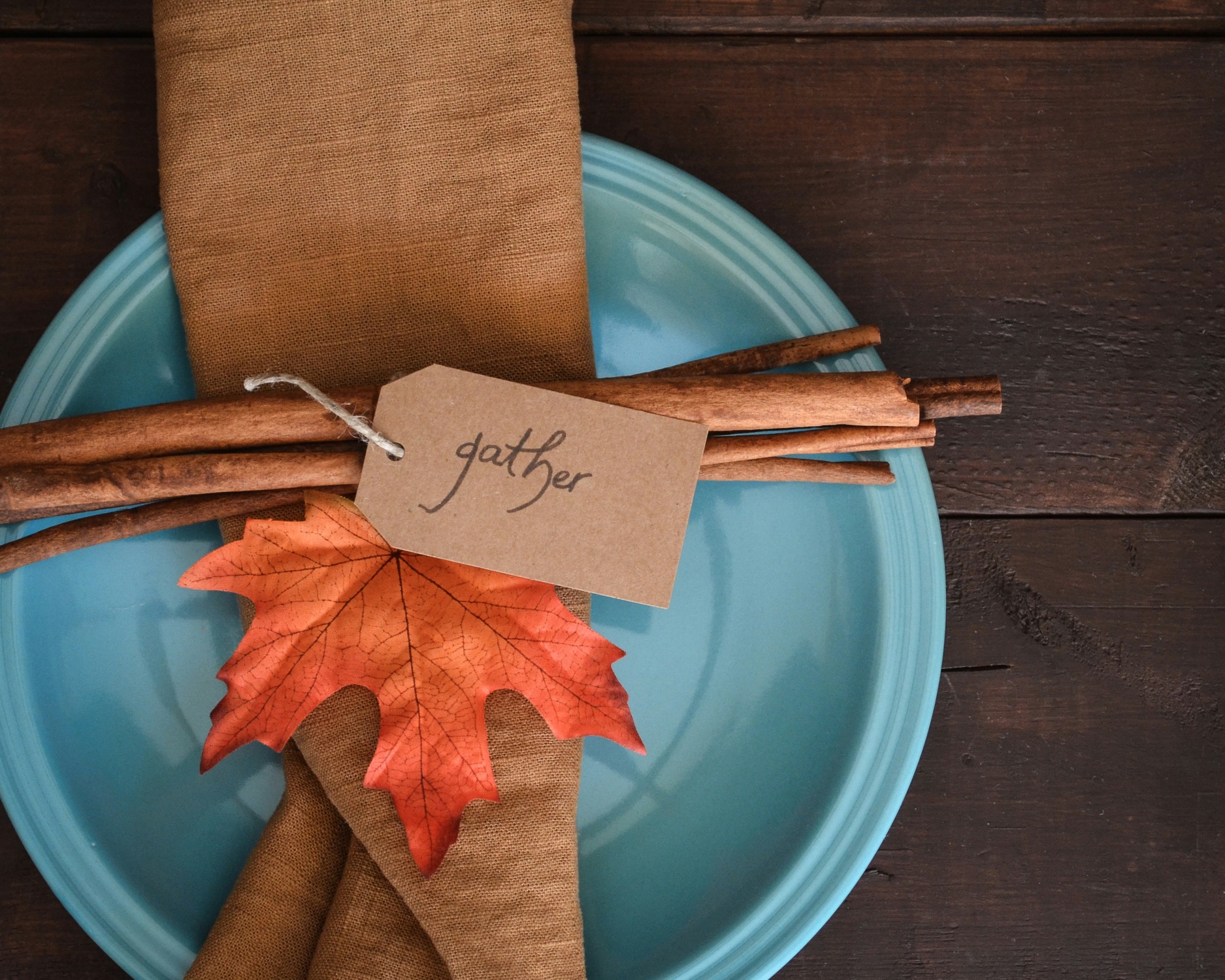 Elegant autumn table setting with gather tag and fall leaf decoration for harvest dinner fundraising events